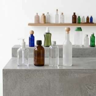Clear and amber PET cosmetic bottles with pumps and caps by Alpha Plastic & Packaging Industries Ltd.