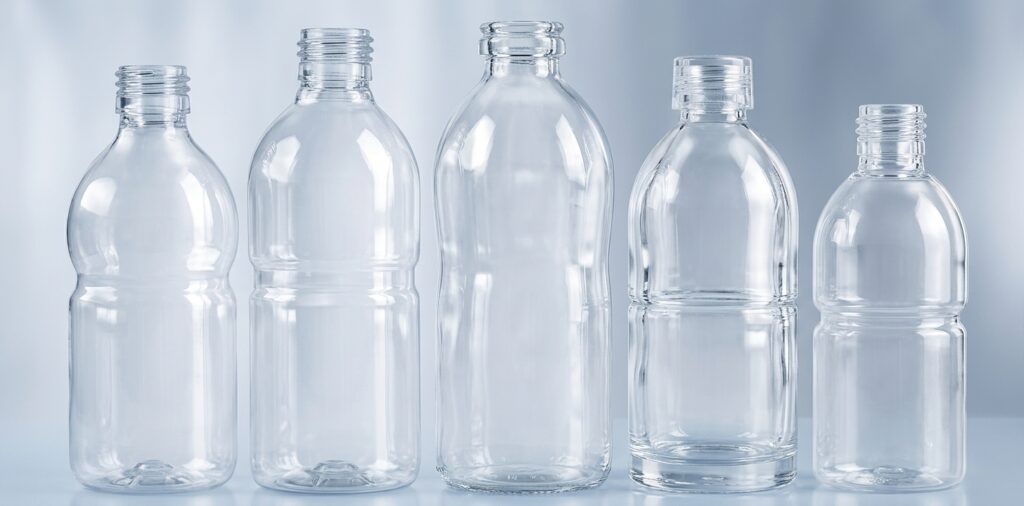 Clear custom plastic PET bottles arranged in various shapes for OEM and private label beverage branding